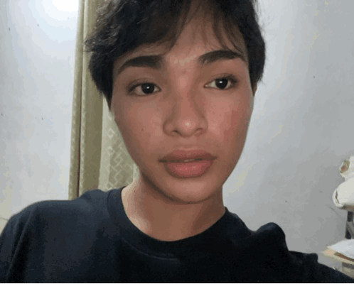 Close Up Of Person's Face In Black Shirt GIF