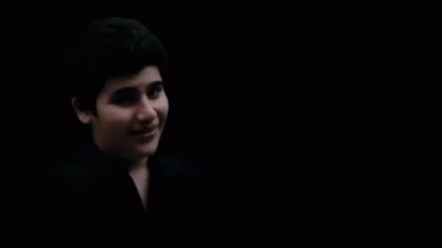 Close Up Of Person's Face In Darkness GIF