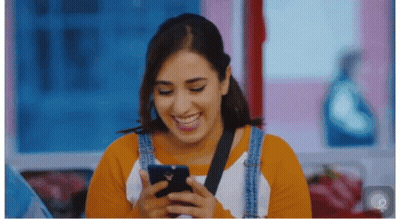 Close Up Of Person's Face With Blurred Flowers And Trees GIF