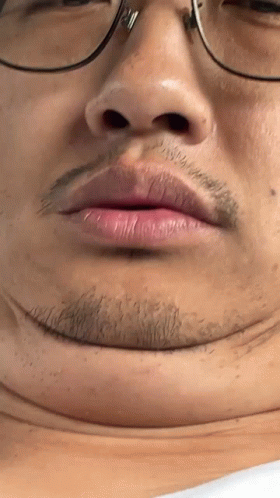 Close Up Of Person's Face With Glasses And Beard GIF