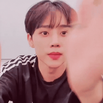 Close Up Of Person's Face With Hand In Front GIF