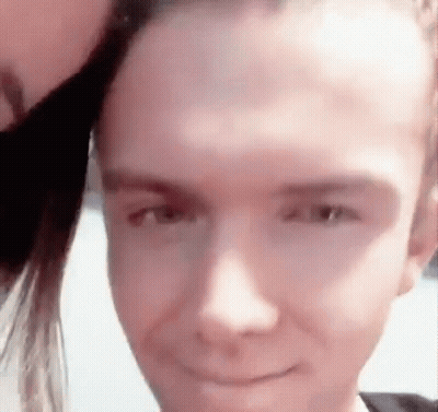 Close Up Of Person's Face With Woman Behind GIF