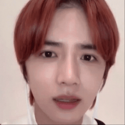 Close Up Of Person With Red Hair And White Shirt GIF