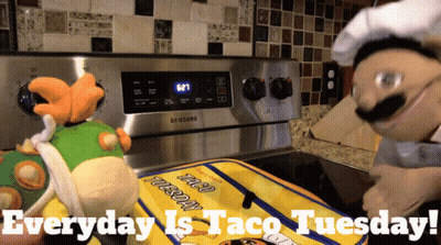 Close Up Of Taco With Lettuce And Cheese GIF