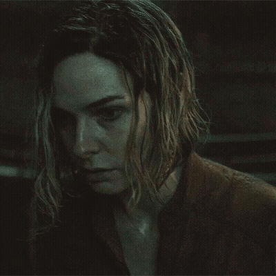 Close Up Of Woman's Face In Dark Room GIF