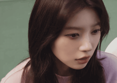 Close-Up Of Woman's Face In Purple Sweater GIF