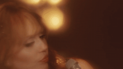 Close Up Of Woman's Face With Blurry Lights Background GIF