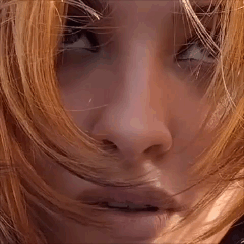 Close Up Of Woman's Face With Hair Blowing GIF