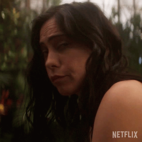 Close Up Of Woman's Face With Netflix Logo Behind Her GIF