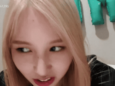 Close Up Of Woman's Face With Number 61195 GIF