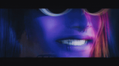 Close Up Of Woman's Face With Purple Hair GIF