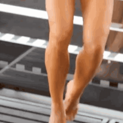 Close Up Of Woman's Legs And Feet Walking On Wooden Floor GIF