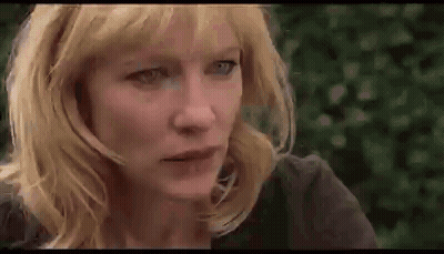 Close Up Of Woman With Blonde Hair And Blue Eyes Looking At Camera GIF