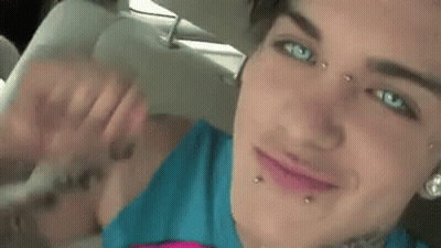 Close Up Of Woman With Face Piercings And Arm Tattoo GIF