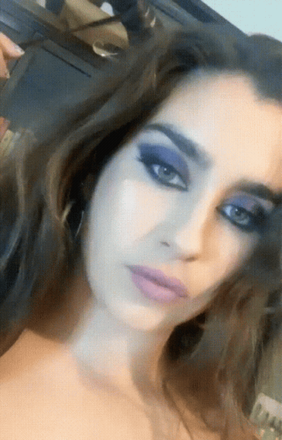 Close-Up Of Woman With Purple Eye Makeup GIF