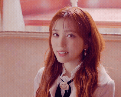 Close Up Of Woman With Red Hair And Earrings GIF