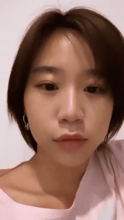 Close-Up Of Woman With Short Brown Hair And Earrings GIF