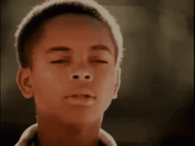 Close Up Of Young Boy Face On Black Background GIF