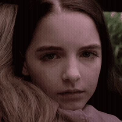 Close Up Of Young Girl With Woman Arm Around Neck GIF