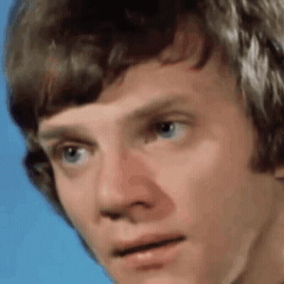 Close Up Of Young Man's Face On Blue Background GIF