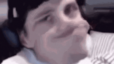 Close Up Person Making Funny Face On Bed GIF