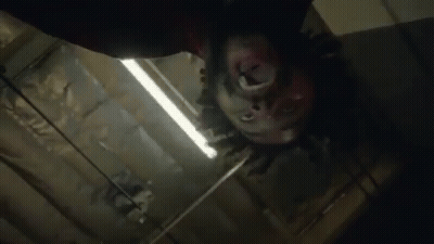 Close Up Person's Head Hanging From Ceiling GIF