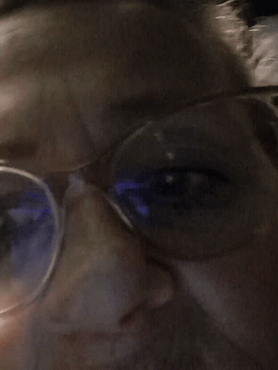 Close Up Person With Glasses And Blue Light GIF