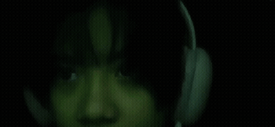 Close Up Person With Headphones in Dark Room