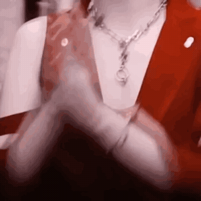 Close Up Person With Necklace And Red Vest GIF