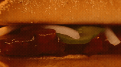 Close Up Sandwich With Meat And Vegetables On Bun GIF