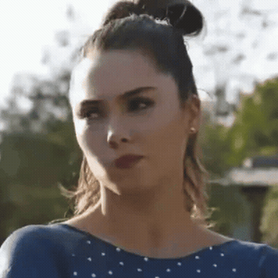 Close Up Woman Face With Bun And Earrings GIF