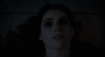 Close-Up Woman Face With Dark Background GIF