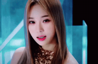 Close Up Woman Face With Long Hair And Gold Top GIF