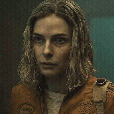 Close Up Woman In Brown Jacket With Badge GIF