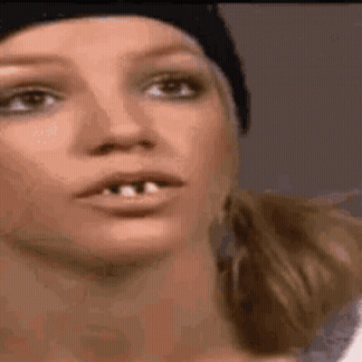 Close-Up Woman Missing Teeth In Beanie GIF