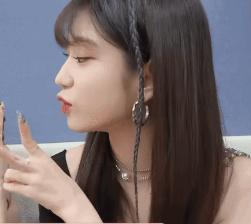 Close Up Woman's Face Braided Hair Earrings GIF