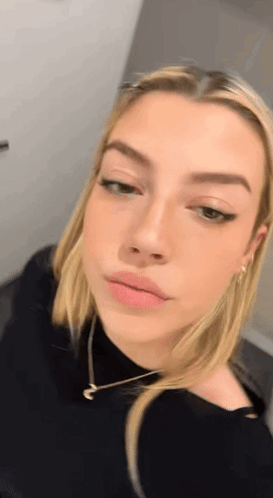 Close Up Woman's Face Wearing Necklace GIF