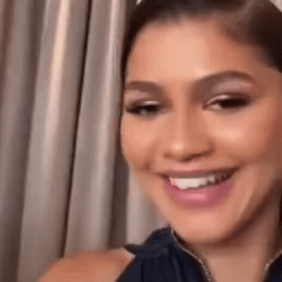 Close Up Woman Smiling In Front Of Curtain GIF