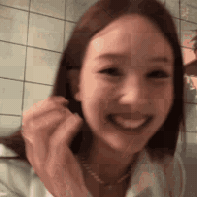 Close Up Woman Smiling In Front Of Tile Wall GIF