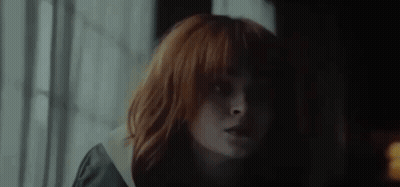 Close Up Woman With Red Hair And Bangs GIF
