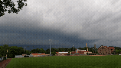 Cloudy Sky Over Baseball Field With Buildings GIF