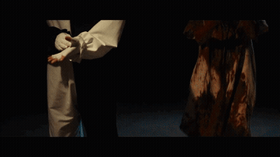Clown And Woman With Blood On Faces In Dark Room GIF