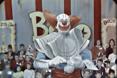 Clown Holding Knife In Front Of Bozo Sign GIF