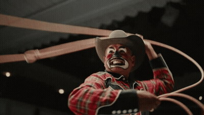 Clown In Cowboy Hat Holding Rope GIF