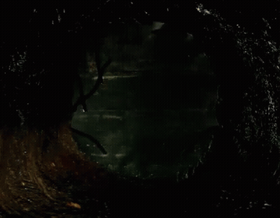 Clown In Dark Room With Brick Wall GIF