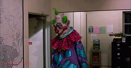 Clown In Purple And Blue Costume GIF