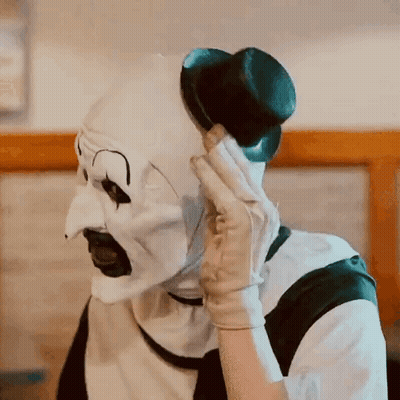 Clown In White Mask Talking On Cell Phone GIF