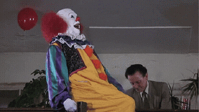 Clown Next To Man In Suit And Tie GIF