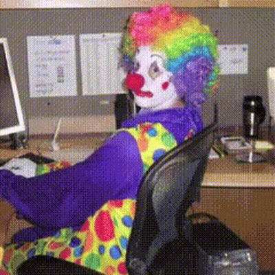 Clown Sitting At Desk With Computer GIF