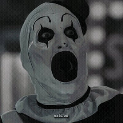 Clown Sitting At Table With Hands Folded GIF